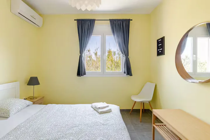 A cheerful twin room dressed in Mediterranean yellow